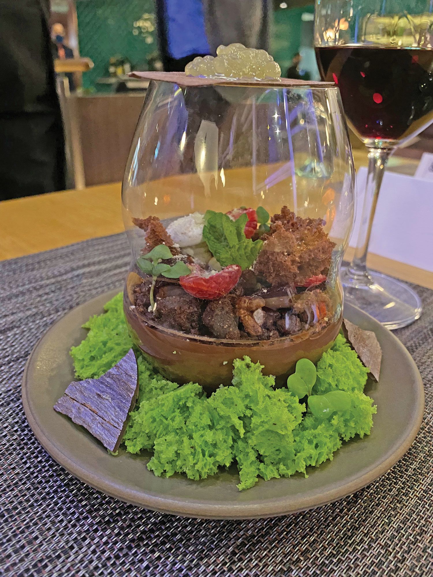 The Looking Glass pistachio cake dessert comes in what appears to be a terrarium. (TW photo by Johanna Jainchill)