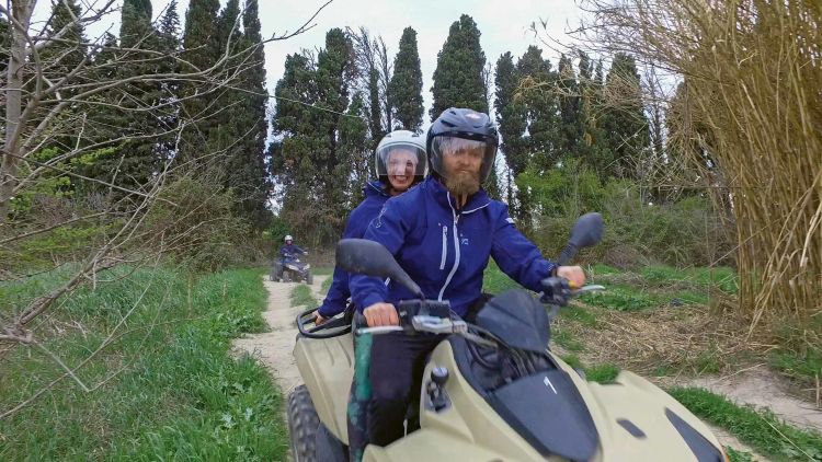 Health and wellness guru Mike Bledsoe rides an ATV through the French countryside with his wife.