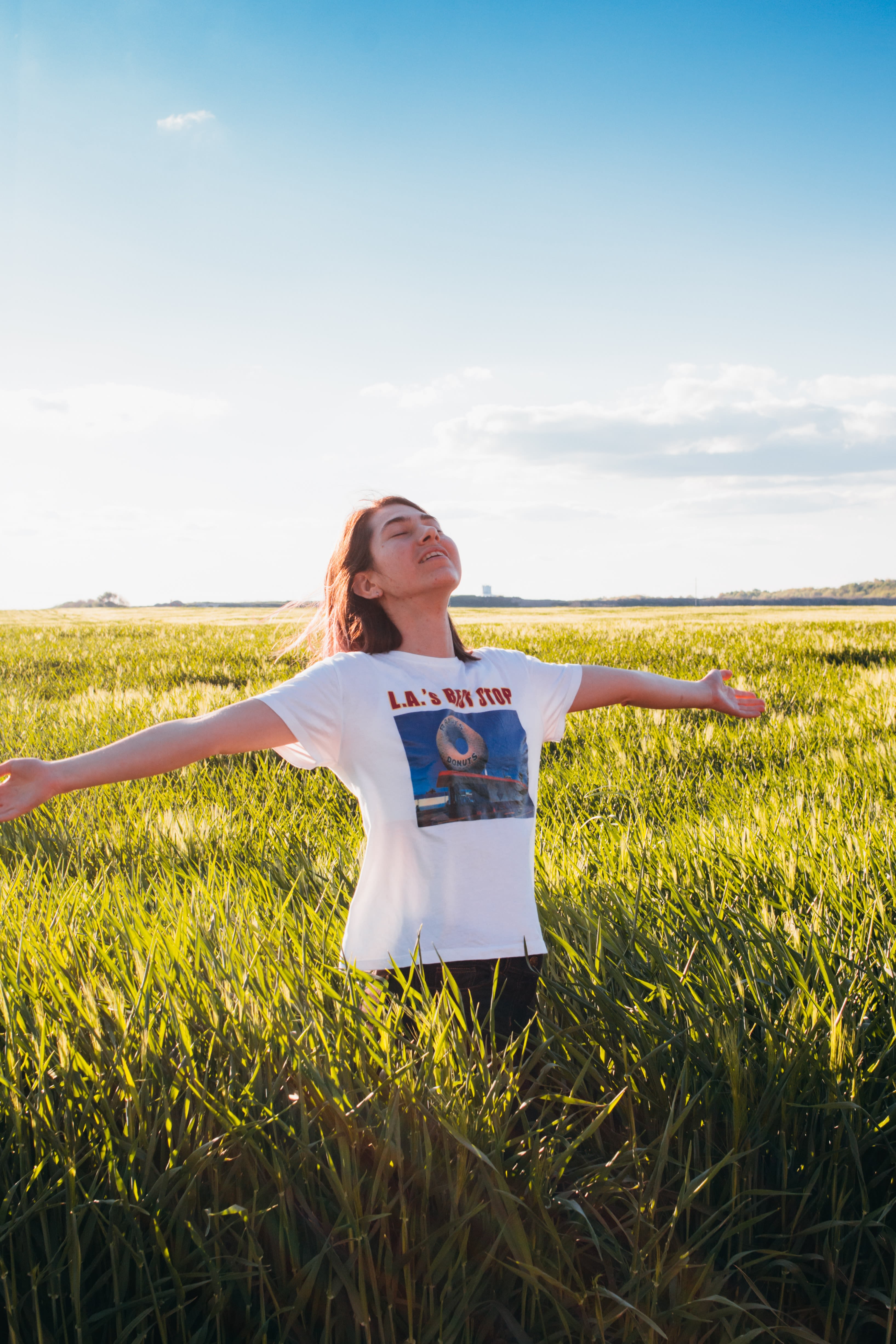 woman standing in green field