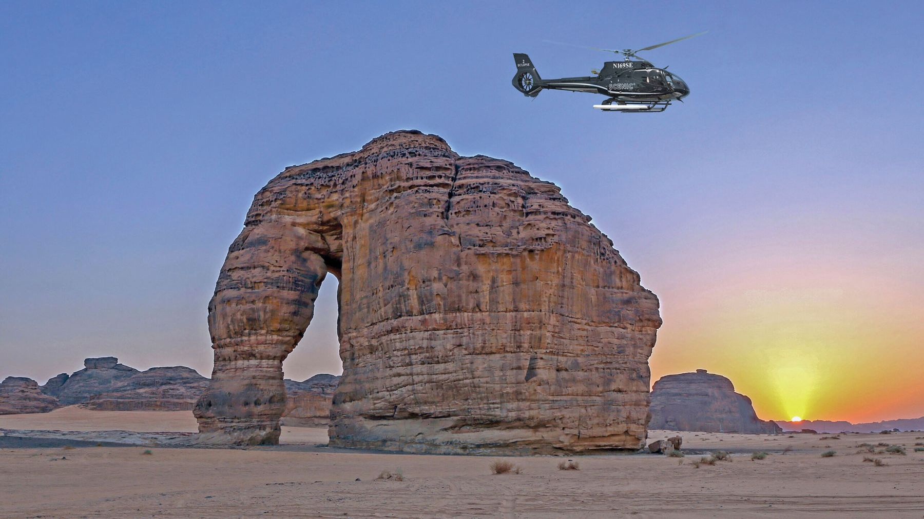 A helicopter from the Scenic Eclipse passing Elephant Rock, part of the AlUla site. (Courtesy of Scenic Cruises)