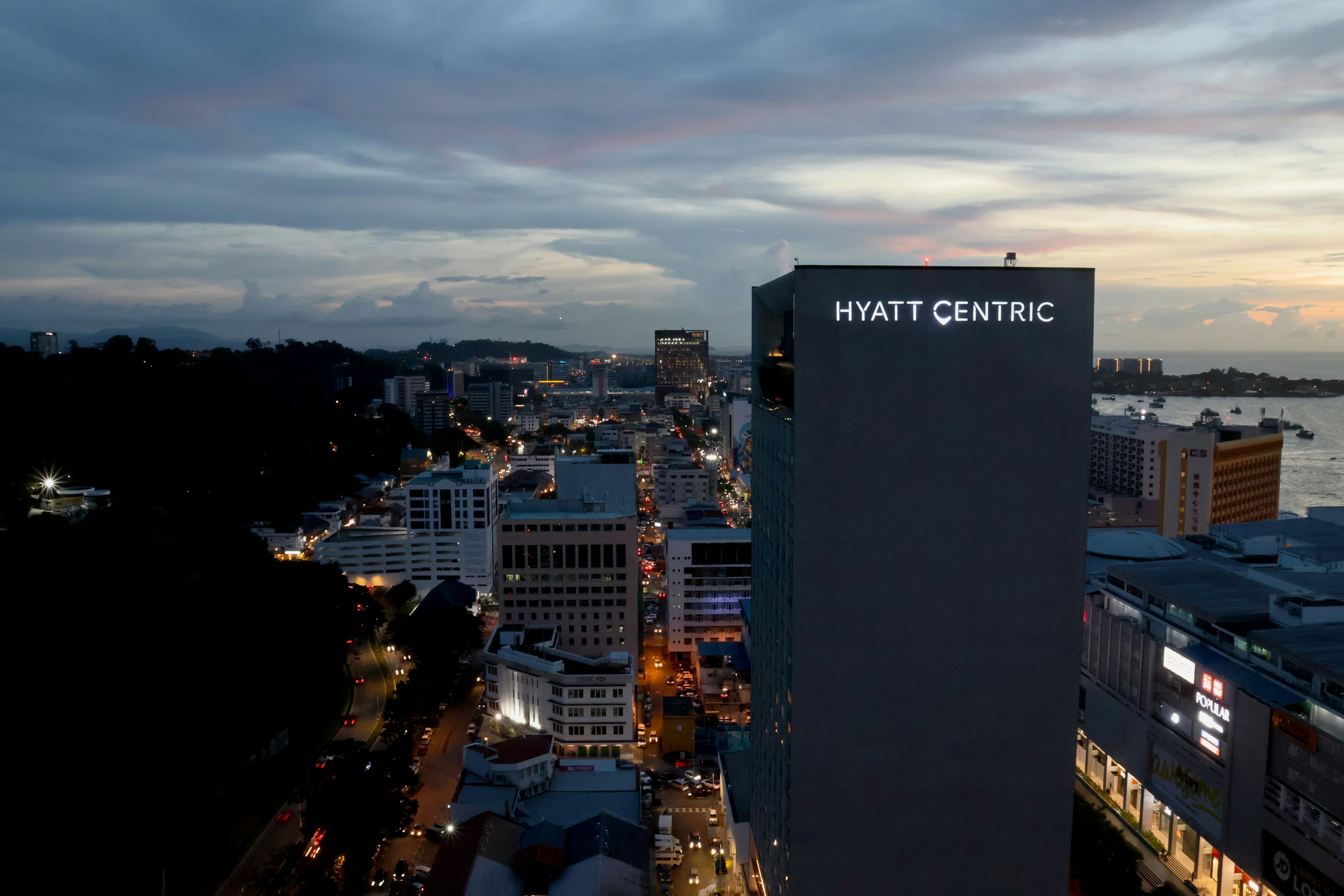 Hyatt centric building overlooking city lights at dusk