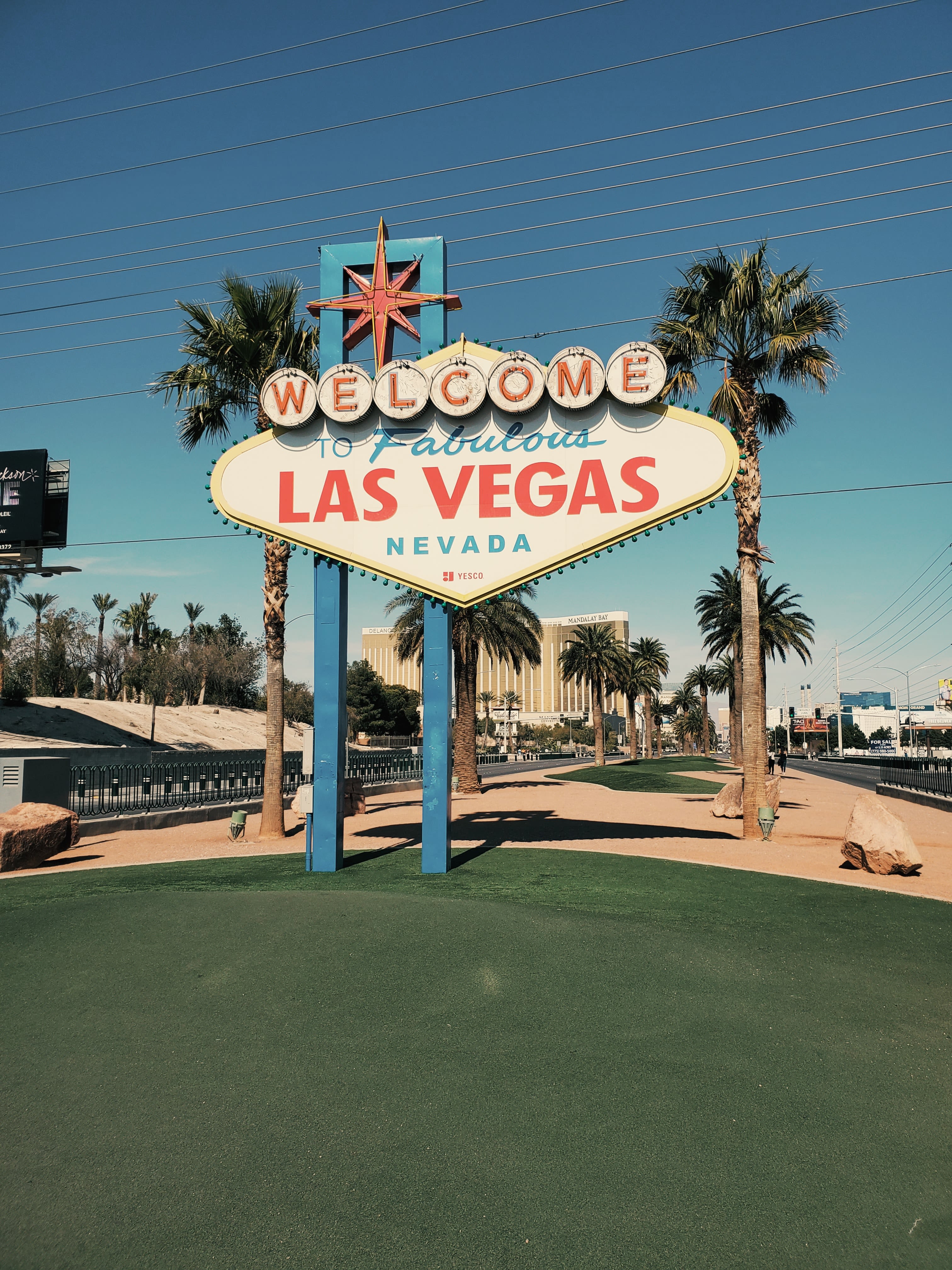 a sign on a street with Welcome to Fabulous Las Vegas sign in the background