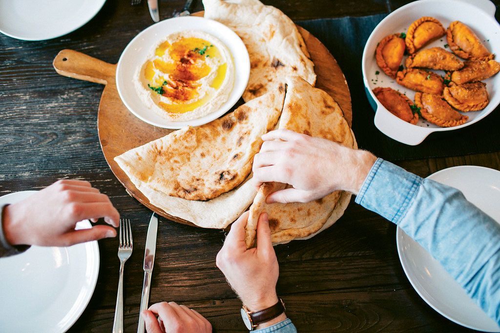 Breaking bread on a Traveling Spoon meal.