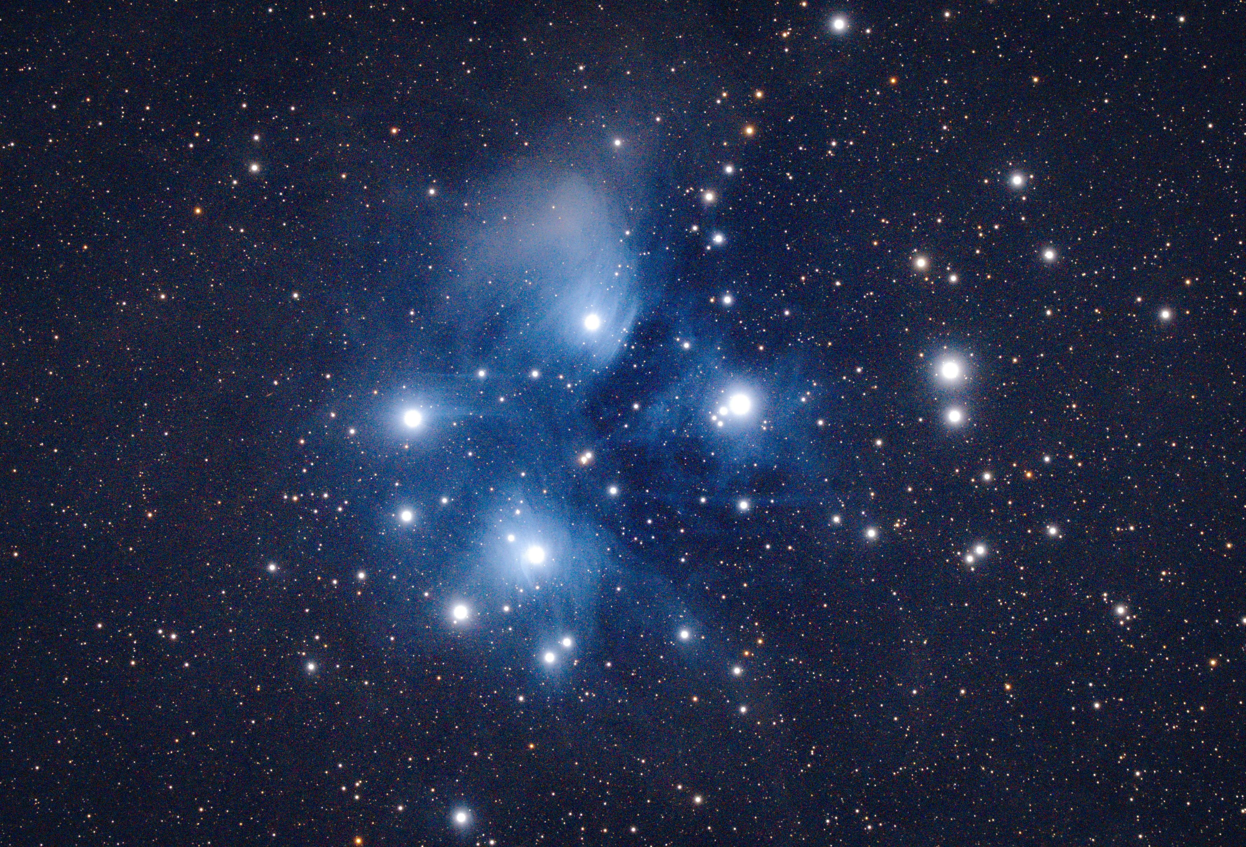 A captivating image of the Pleiades star cluster, showcasing bright celestial bodies against the night sky.
