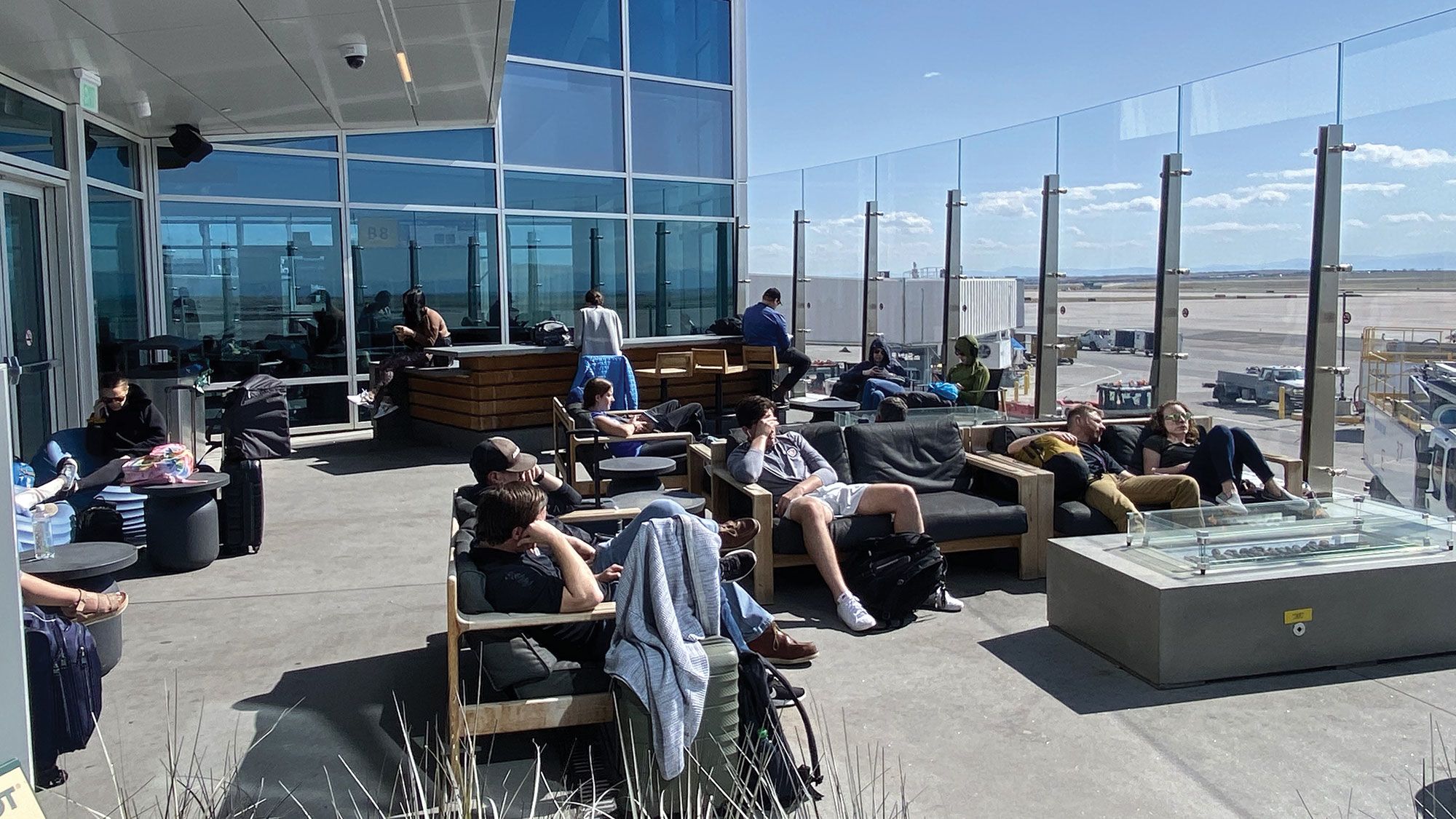 At Denver Airport, travelers get some sun at one of four new air-side patios that will be slated to be open before the end of the year. (TW photo by Robert Silk)