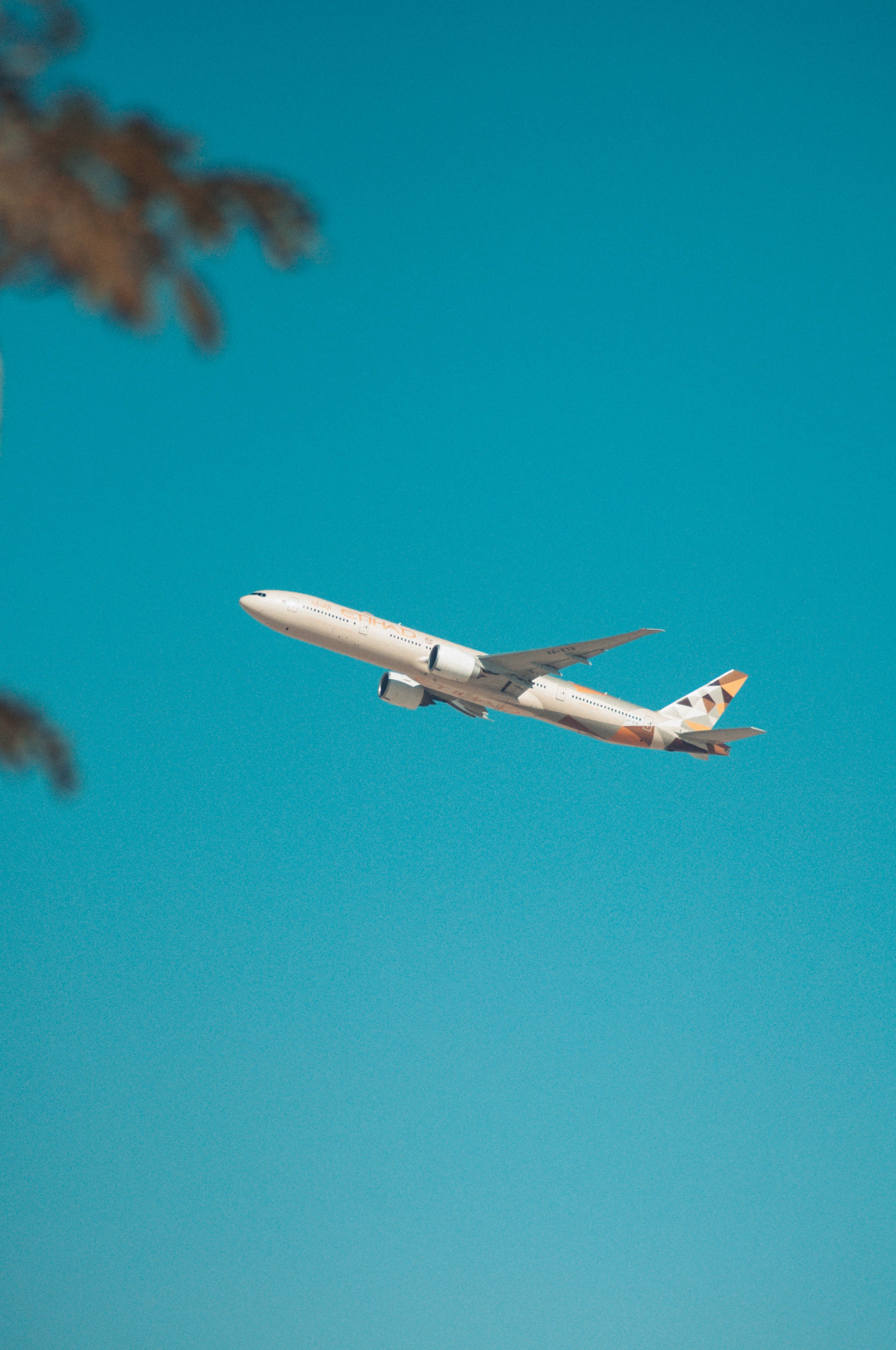 white airplane flying in the sky during daytime