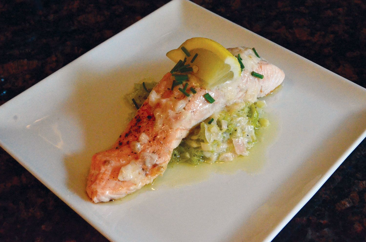 Oceania Cruises chef Renald Macouin walked reporter Jamie Biesiada through making a pan-fried salmon with leek fondue and beurre blanc. (TW photo by Jamie Biesiada)