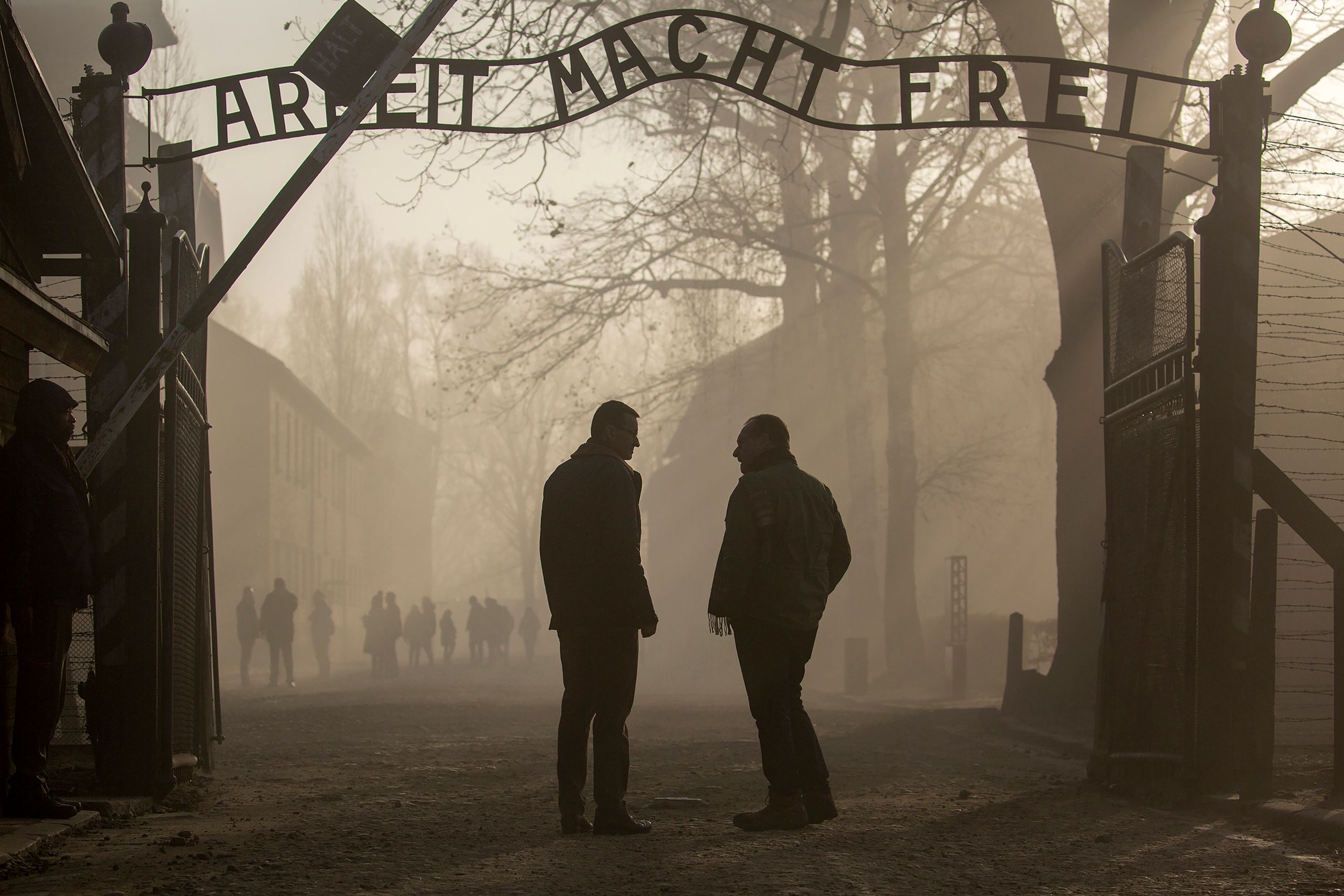 Morawiecki and CBS News travel editor Peter Greenberg at the gate of the Auschwitz concentration camp. Morawiecki signed a controversial law intended to discourage suggestions of Polish complicity in Nazi war crimes committed in Poland. Photo by Karen Ballard