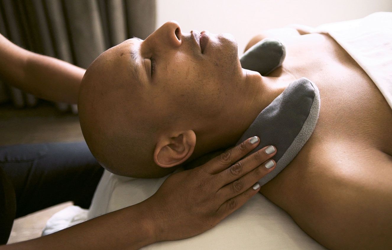 A man gets a massage at a Mynd Spa & Salon location.