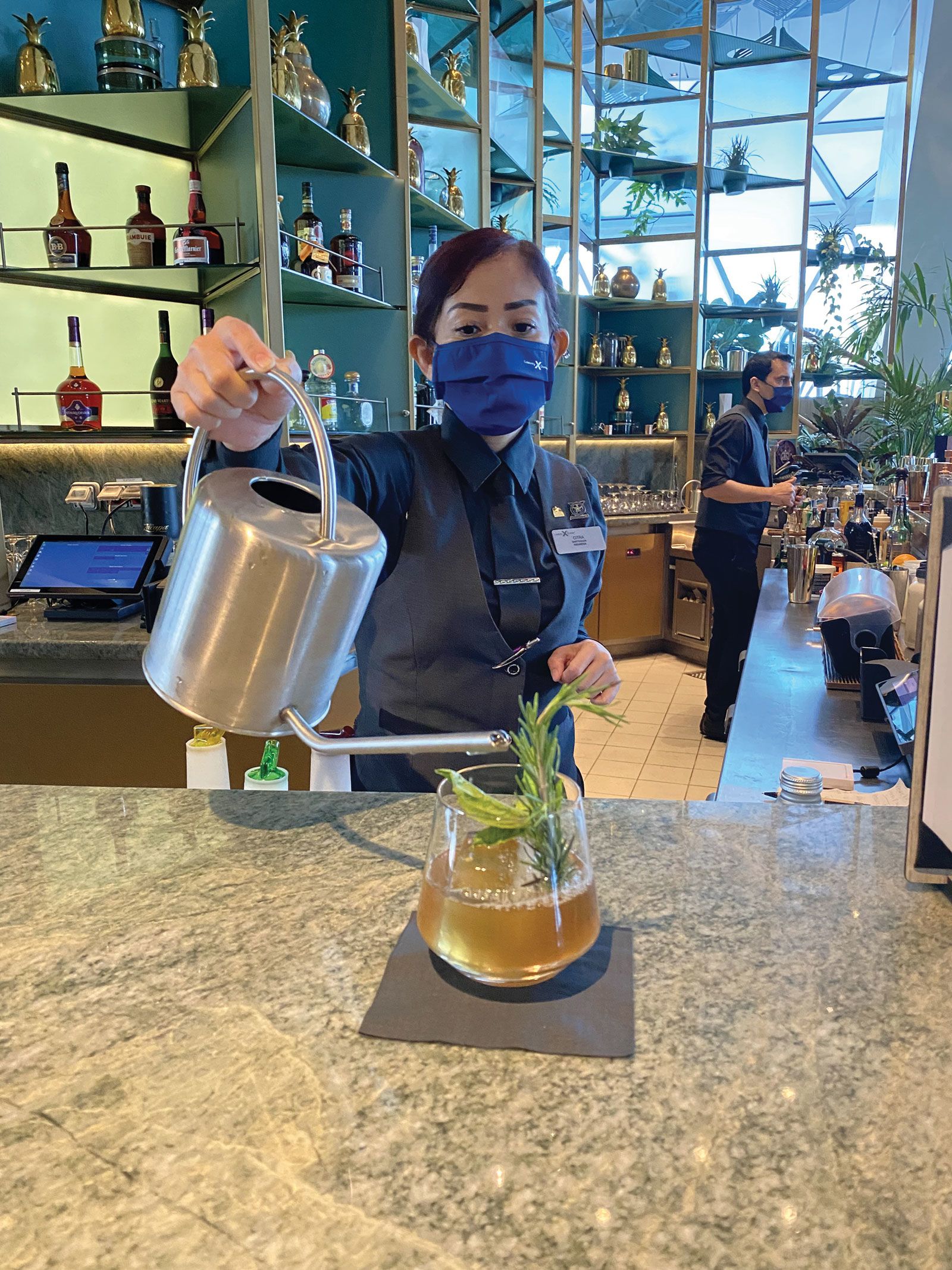 The bartender at Eden on the Edge pouring a Garden Cocktail on the ship’s first sailing since the March 2020 global cruise shutdown. (TW photo by Johanna Jainchill)