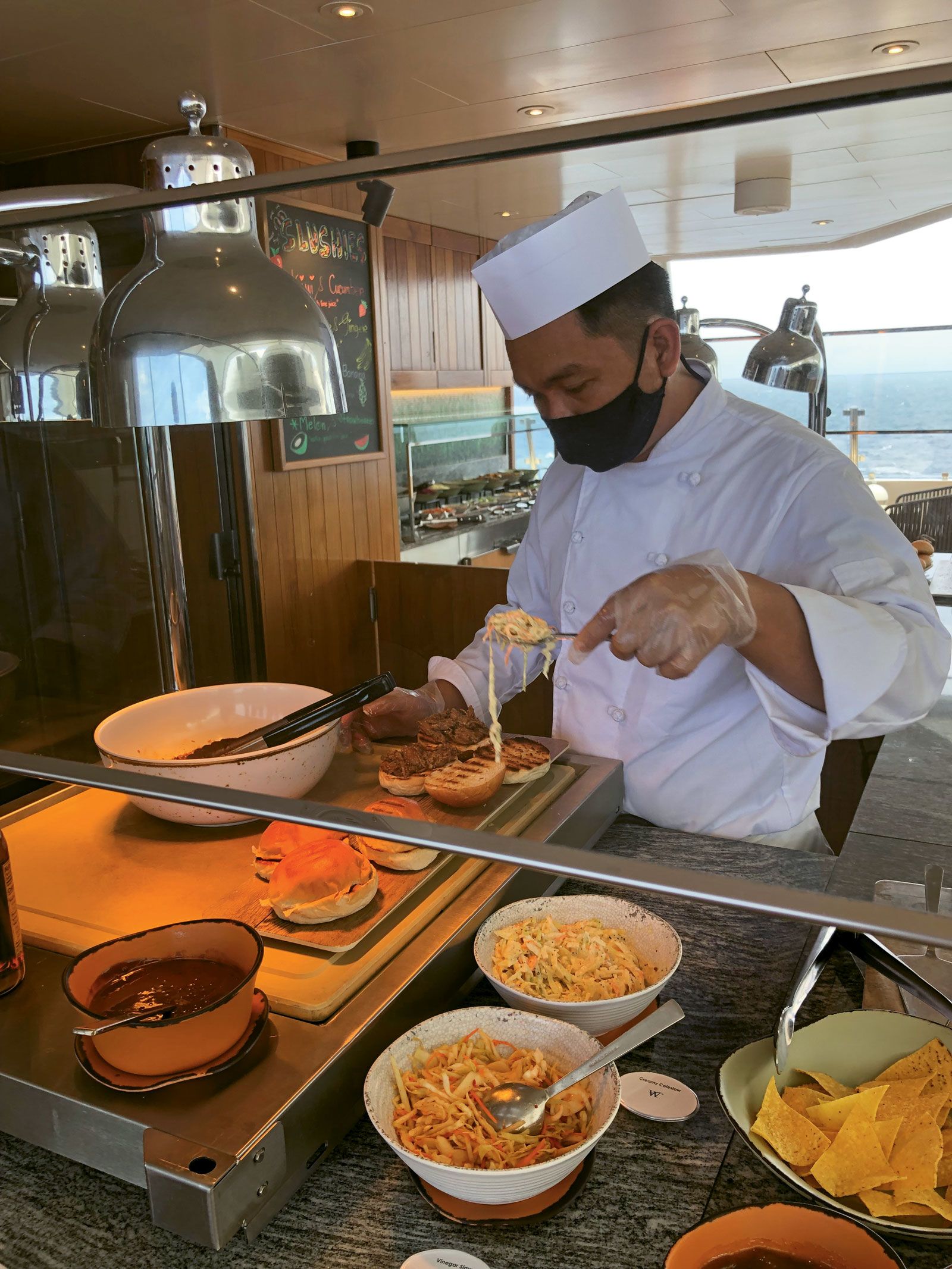 A cook prepares a smoked pork sandwich at the new Star Grill on Deck 8. (Photo by Tom Stieghorst)