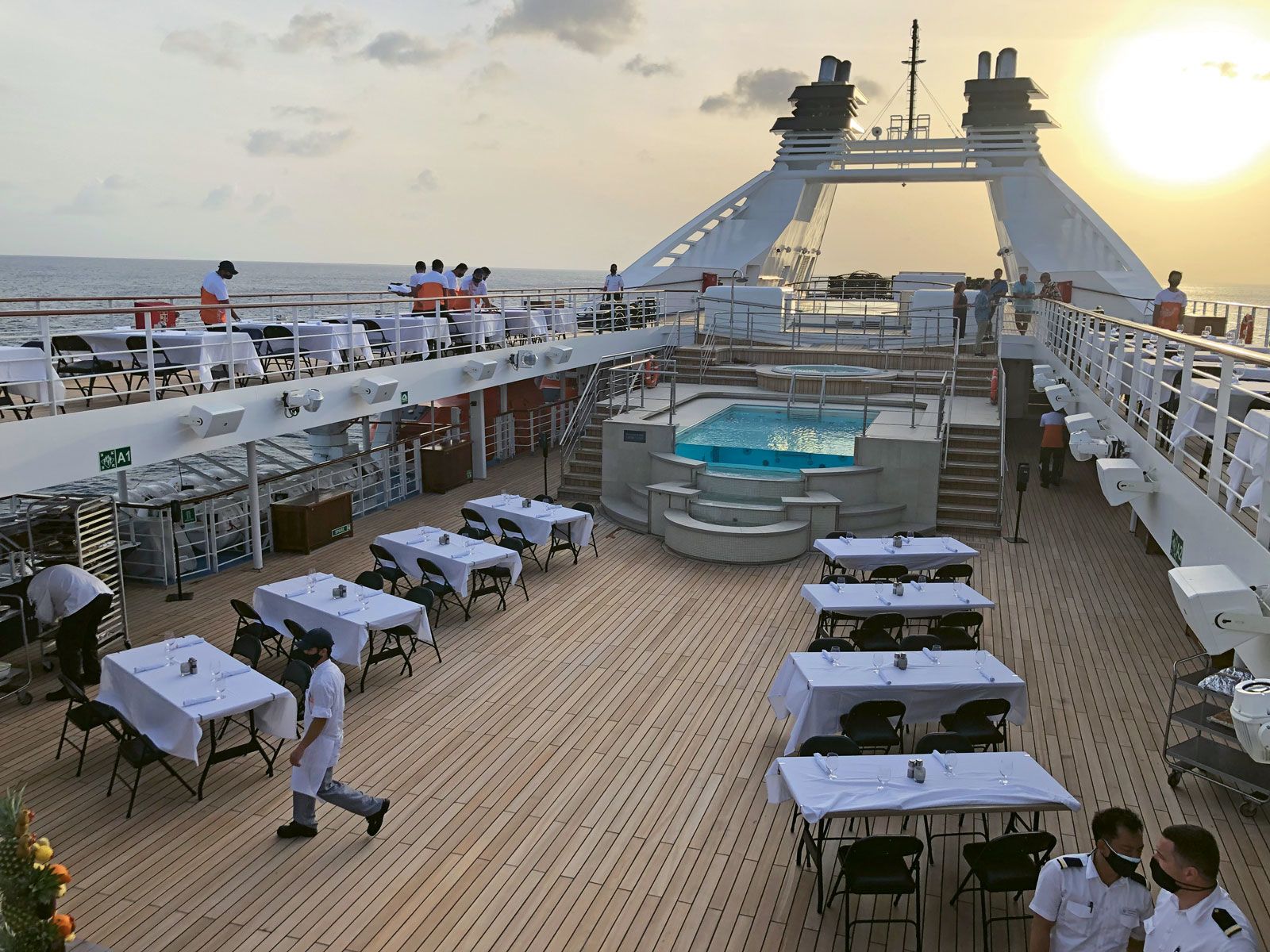 Crew members prepare the line’s signature deck barbecue on the Star Breeze. The line had to modify the itinerary for the ship’s June sailing because it could not meet Covid protocols for its originally scheduled ports of call. (Photo by Tom Stieghorst)