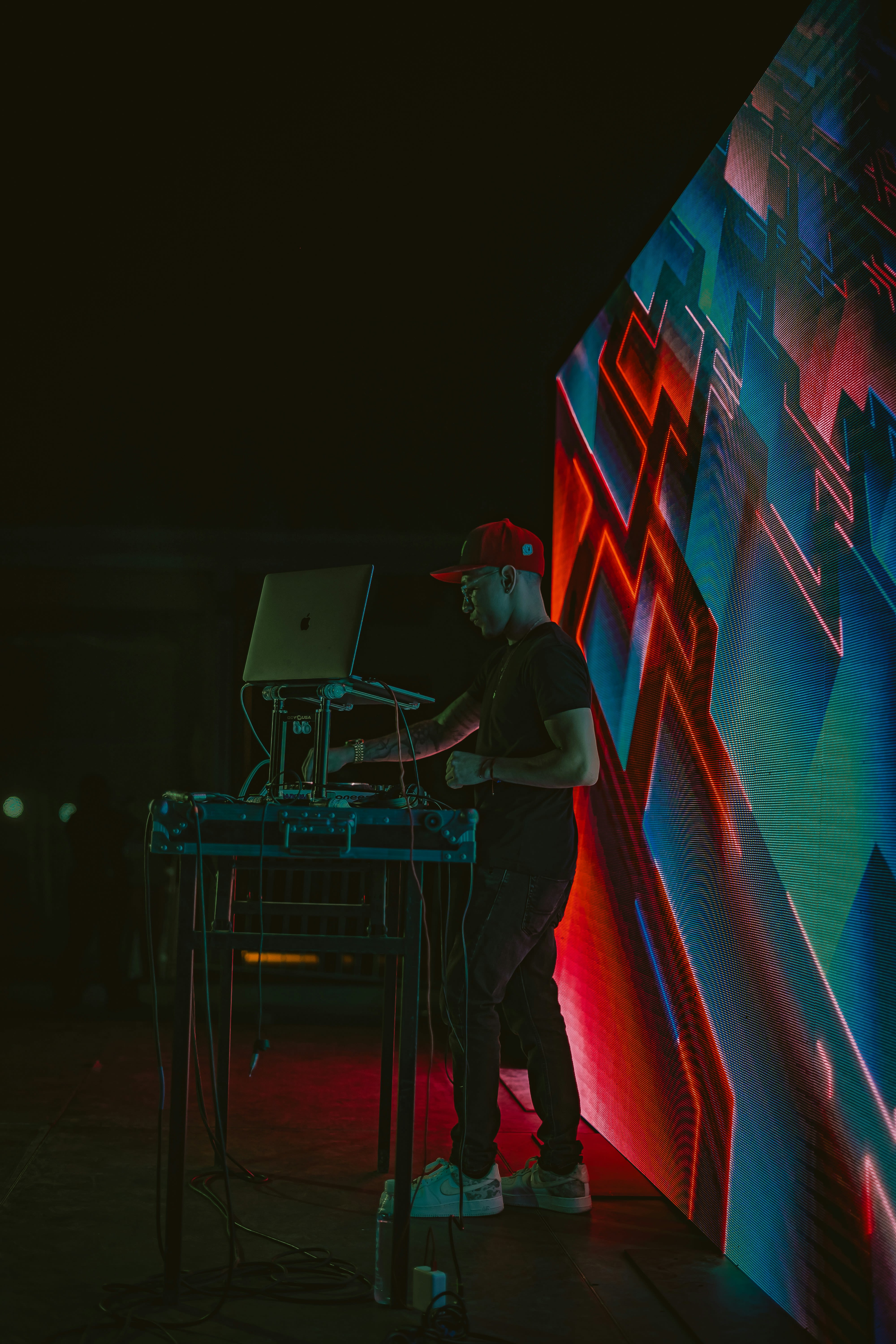 a man standing in front of a large screen