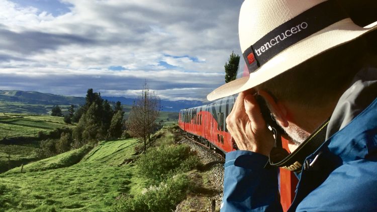 Owen Hardy snapping a photo from the rear observation car of the Tren Crucero in Ecuador. Hardy and his wife, Eleanor Flagler Hardy, turned a love for and expertise in rail travel into a profitable niche.