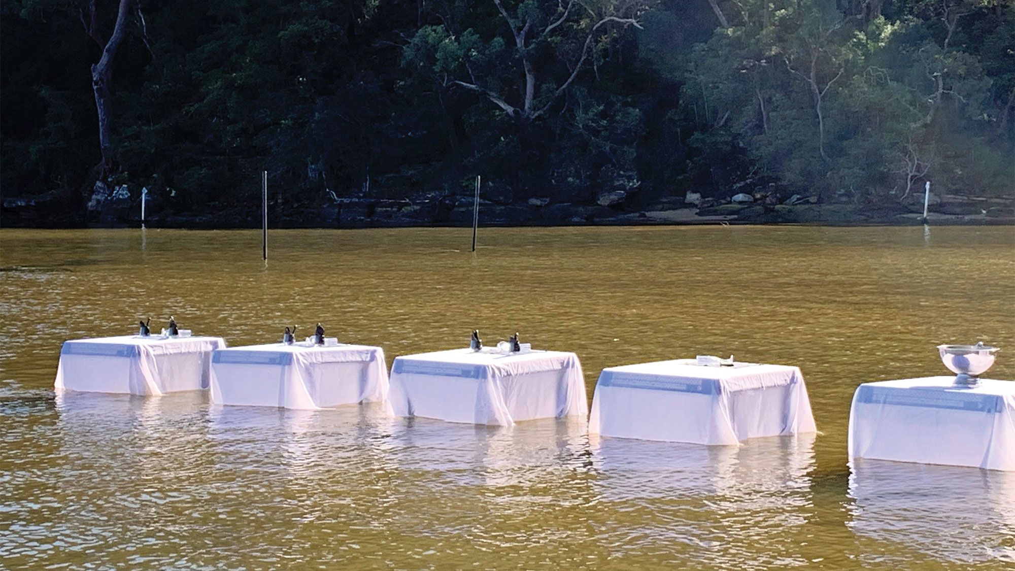 Sydney Oyster Farm Tours now closes its tours with lunch served at tables in the river, an idea born from social-distancing rules. (Photo by Ramsey Qubein)