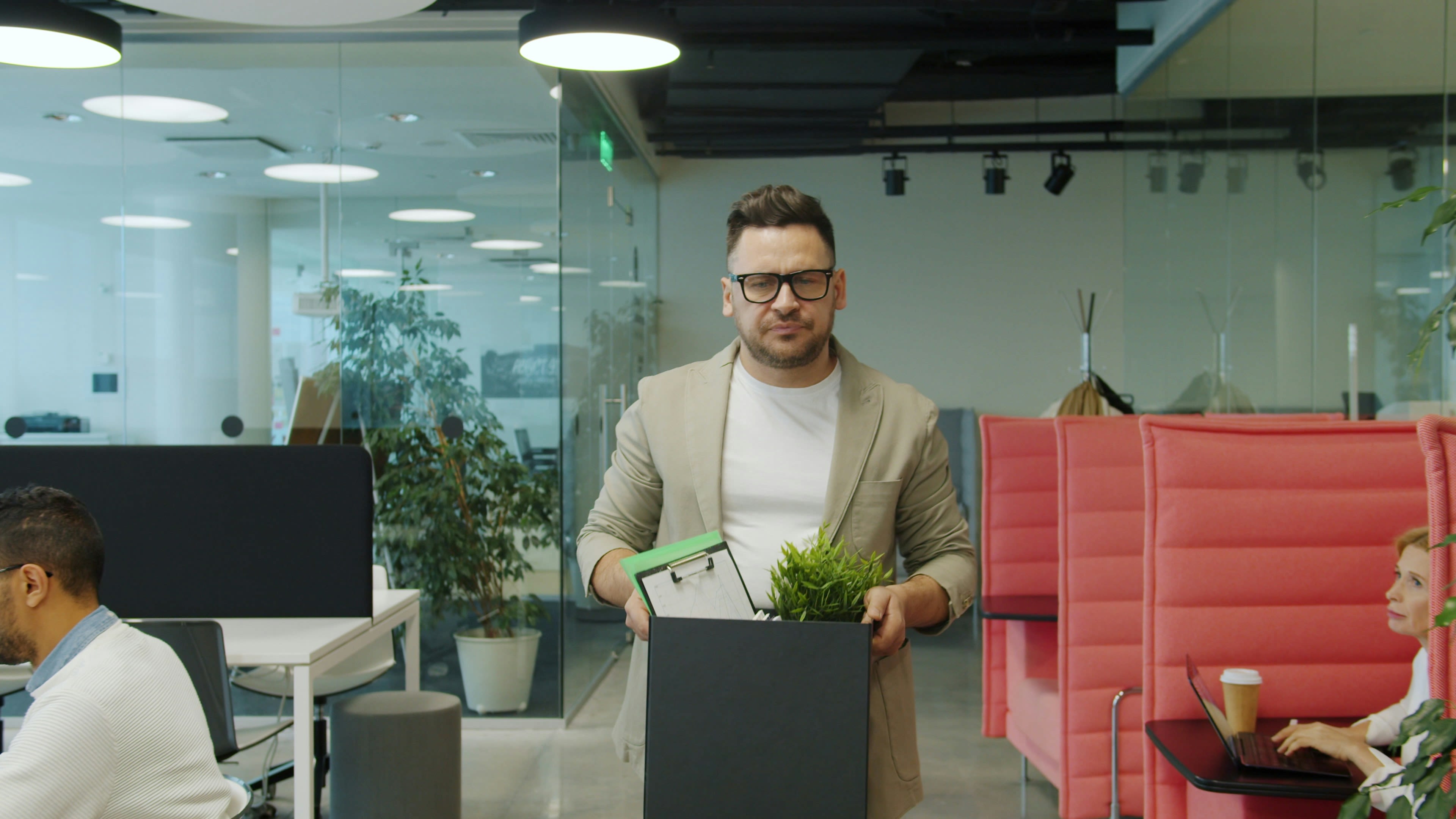 Man carrying box of belongings in office
