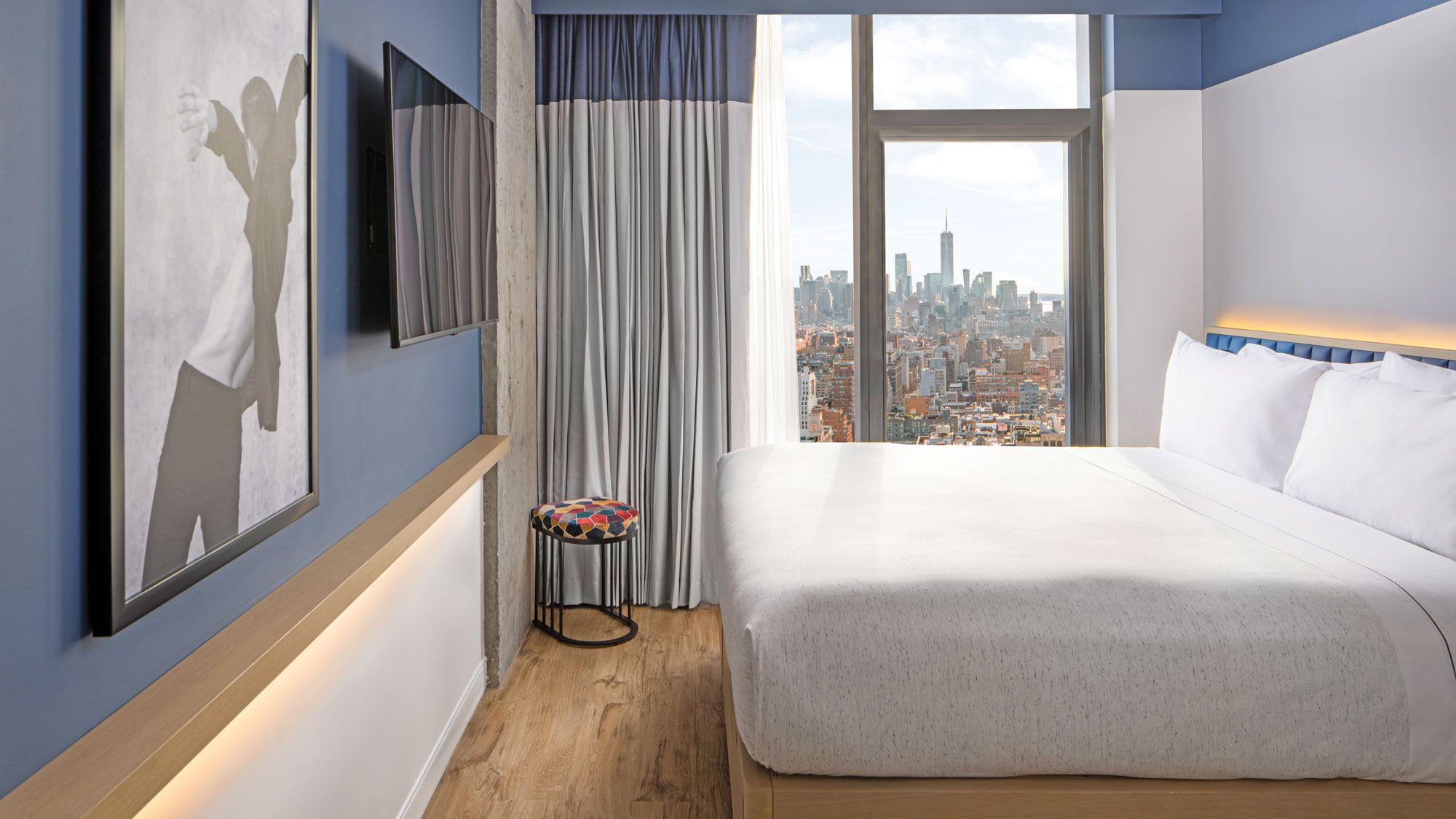 A guestroom at the Stonehill Taylor-designed Motto by Hilton New York City Chelsea illustrates the trend toward less clutter. (Photo by Joe Thomas / Courtesy of Stonehill Taylor)