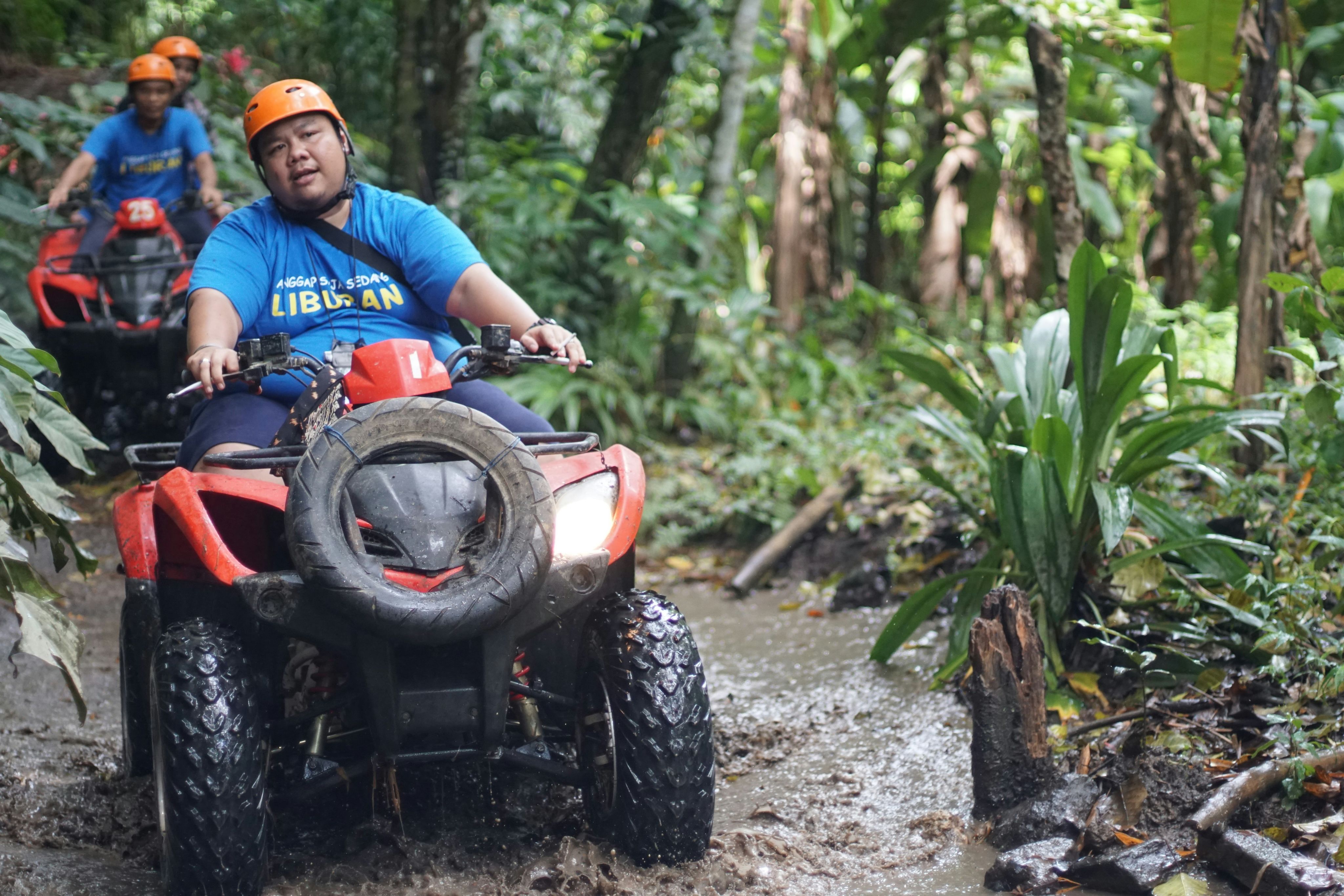 a group of people riding atvs