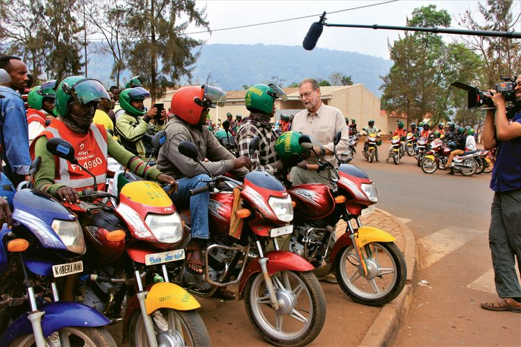  Greenberg hires a mototaxi in Rwanda’s capital city, Kigali.