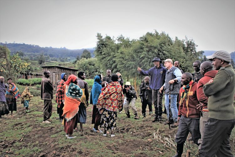 On the way back from a gorilla trek, the president greets residents whose farms abut Volcanoes National Park.