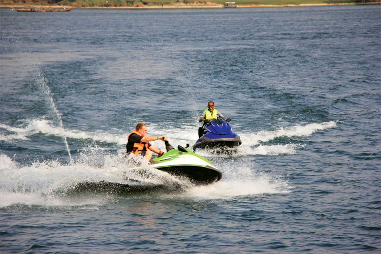 Greenberg and Kagame try their hand at riding personal watercraft on Lake Kivu. 