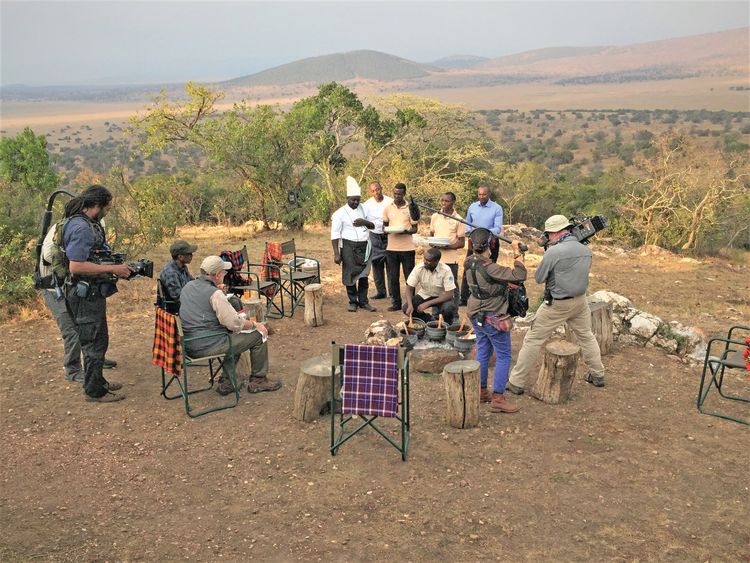 The president and Greenberg have dinner at a bush camp in Akagera National Park.