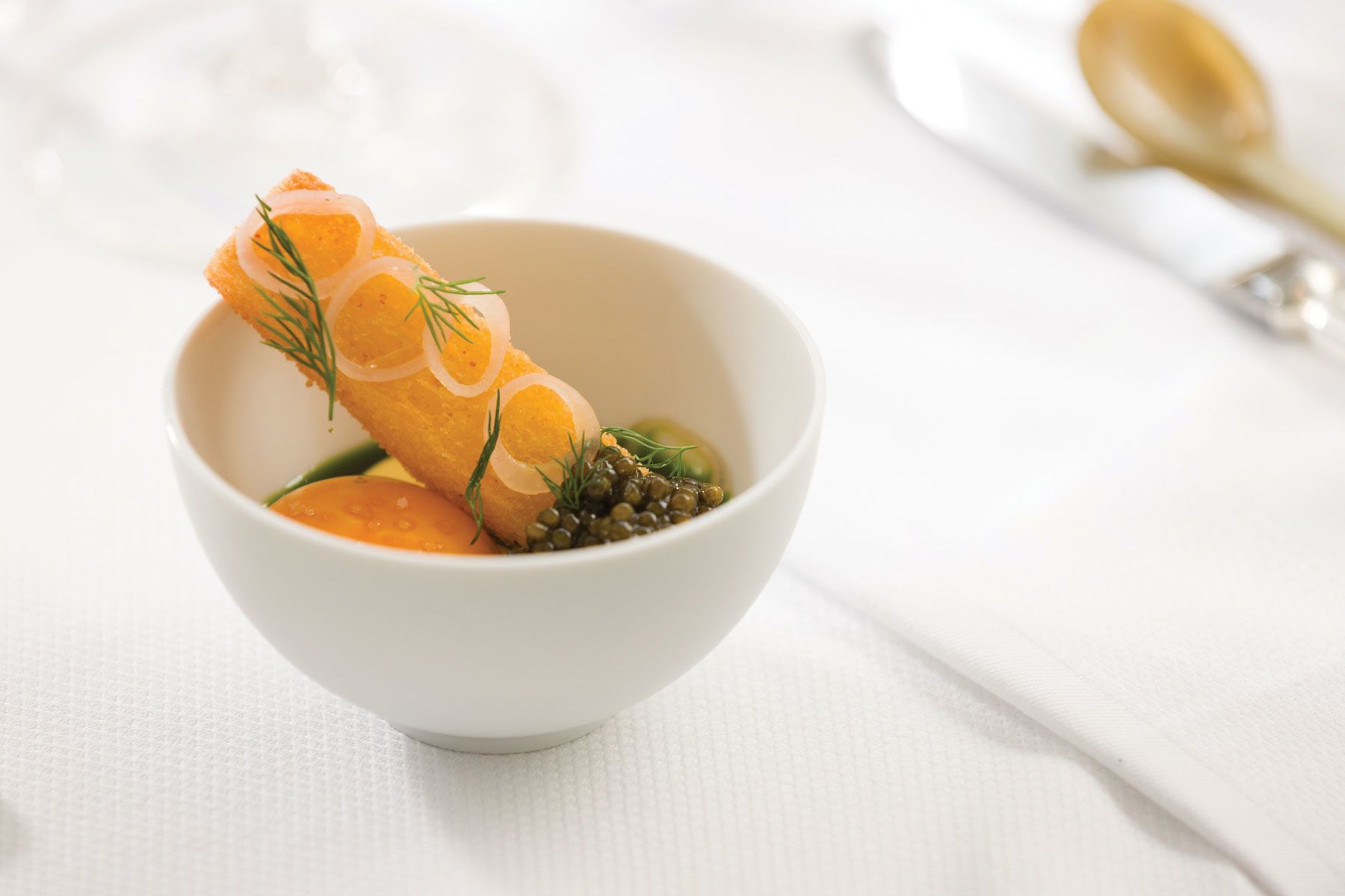 A dish at the Modern known as Eggs on Eggs on Eggs. Ingredients include caviar, egg sauce and fried egg, served with pickled shallots, dill and toasted brioche.