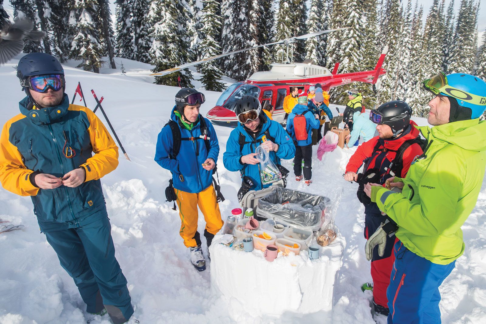 A group with CMH Heli-Skiing & Summer Adventures breaks for food.