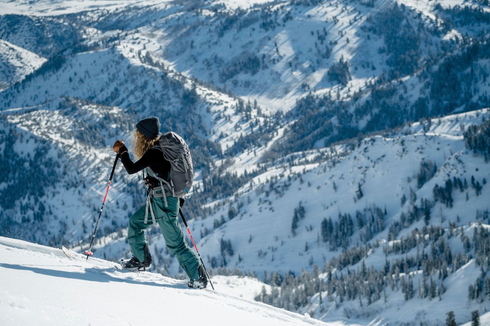 A snowboarder skinning up a slope using a board that splits in two at Powder Mountain in Utah. (Photo by Powder Mountain)