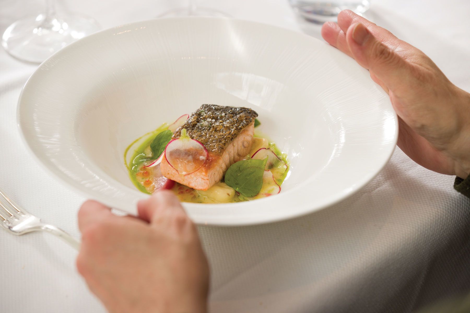 Crispy salmon with potato gnocchi and radishes.