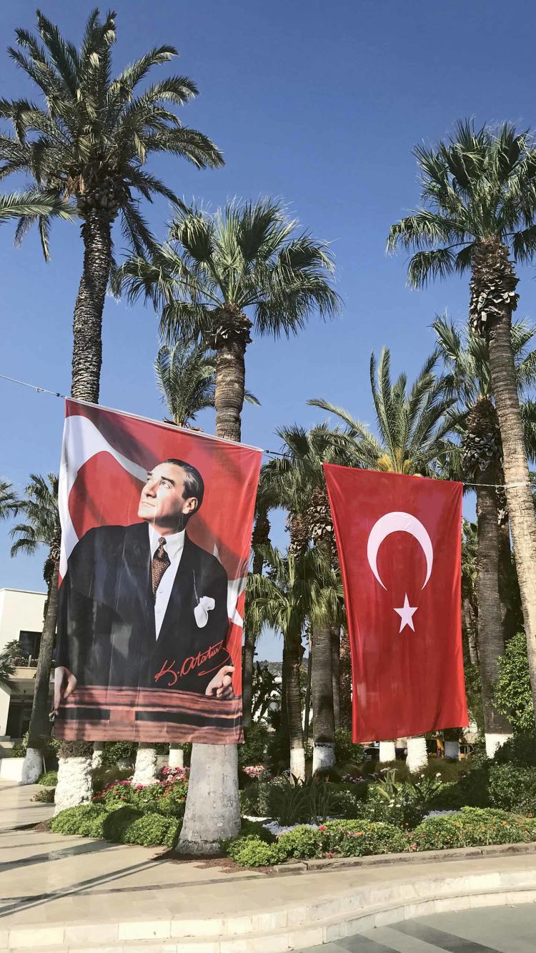 A banner showing Mustafa Kemal Ataturk, the father of the Republic of Turkey, flies alongside the national flag in the town square in Bodrum.
