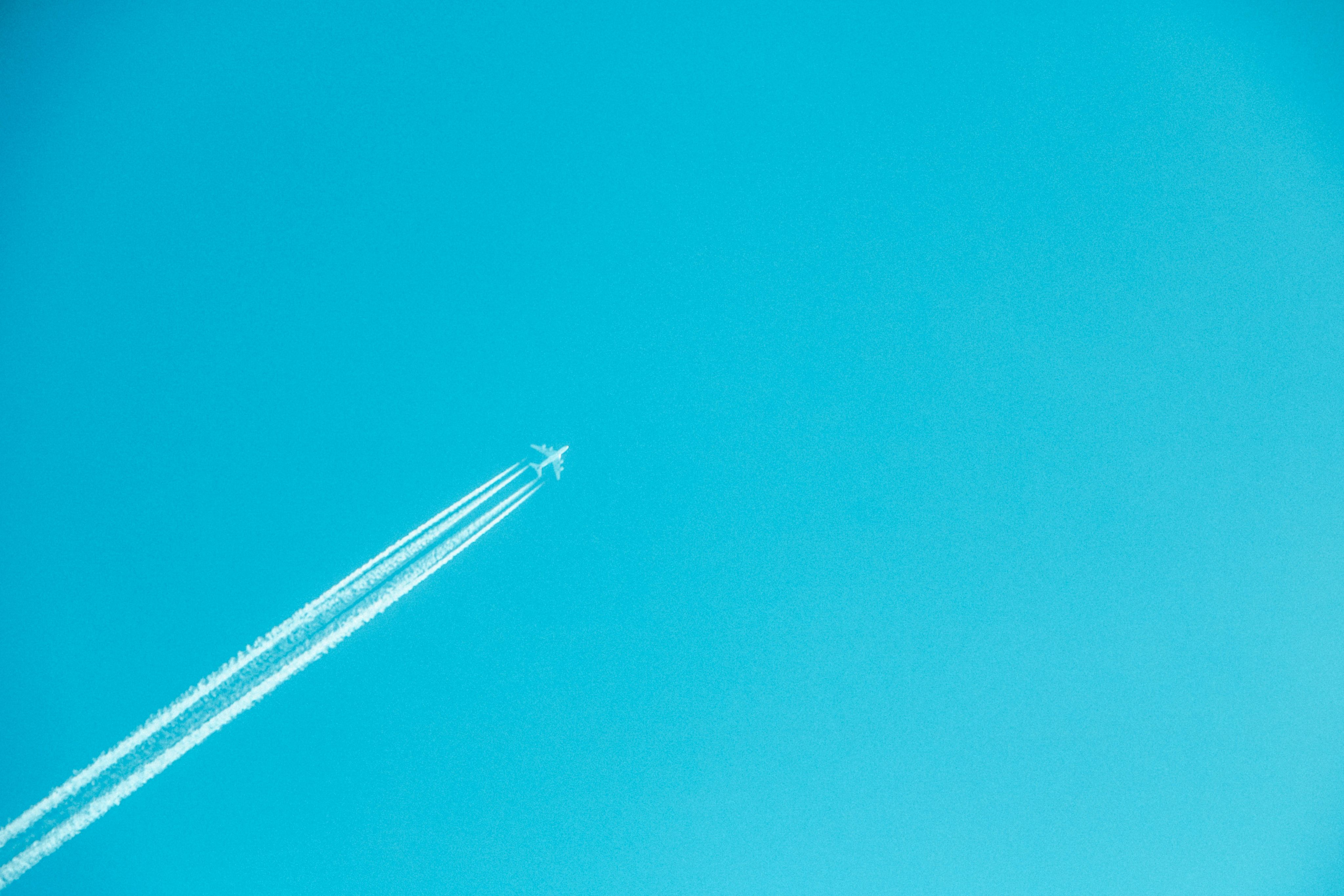 airplane on mid air under clear sky