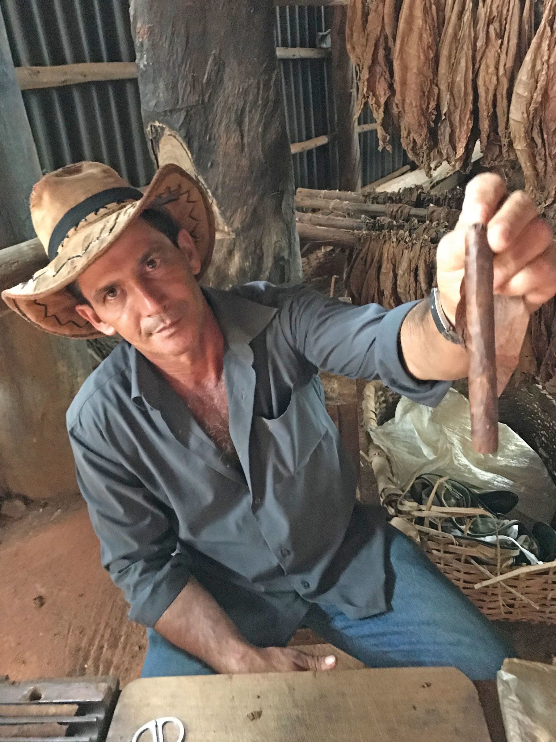 Ernesto holding up a cigar