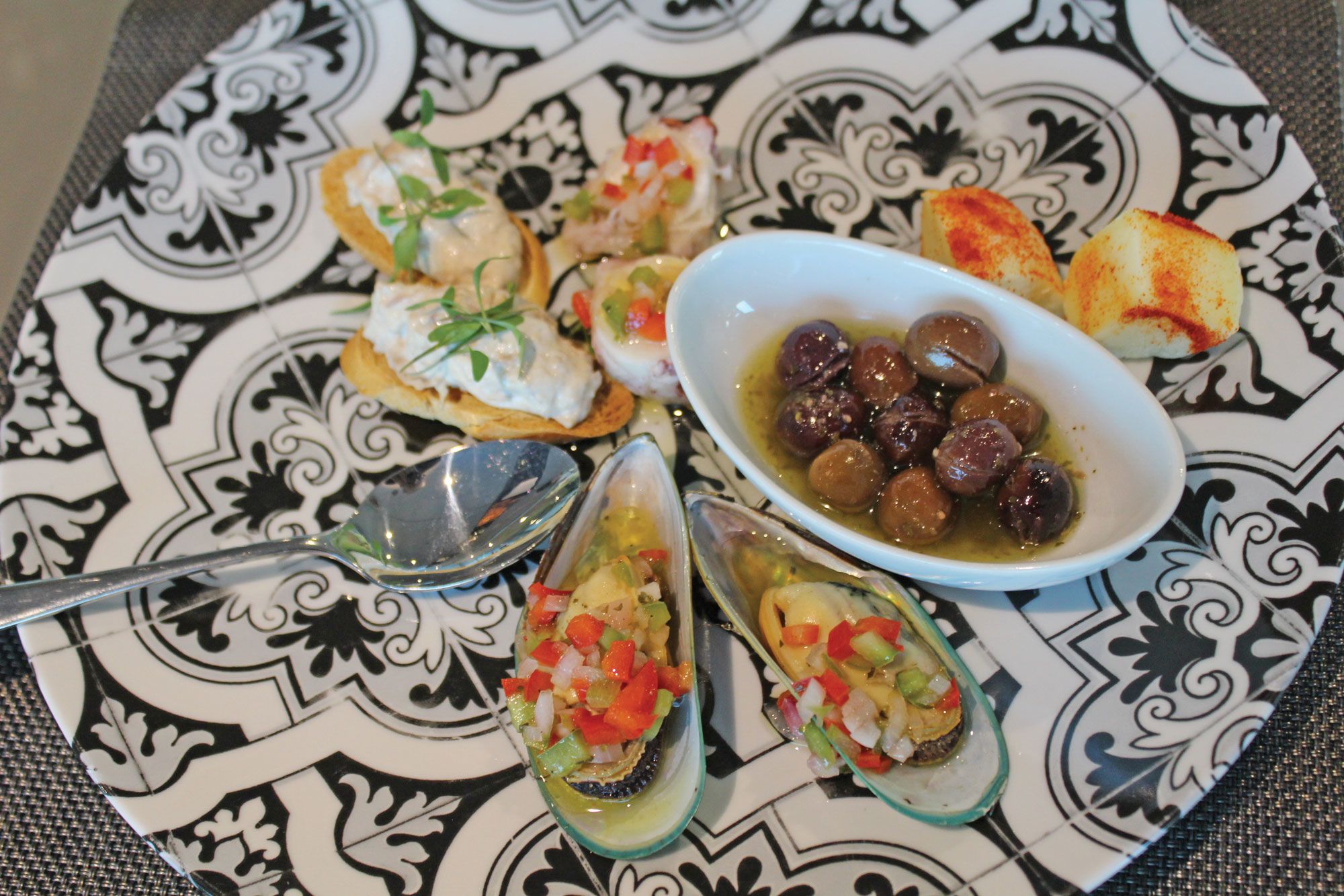 Appetizers including tuna toast, olives and mussels served during the five-course tasting menu at the ship’s Portobellos. (Photo by Richard Varr)
