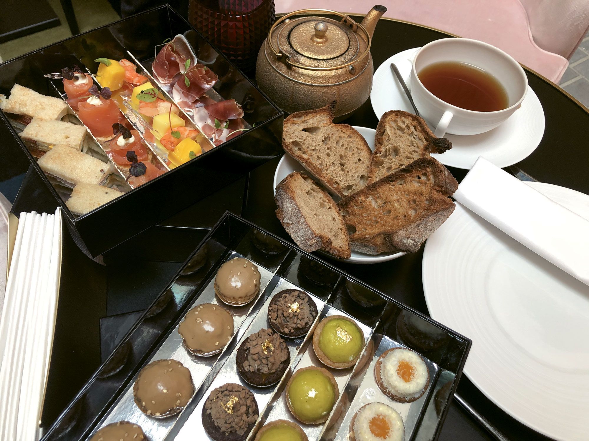Fauchon’s afternoon tea featured ham from Gascony, smoked salmon from Isigny, apple cardamom domes and coconut mango cheesecake. (TW photo by Johanna Jainchill)
