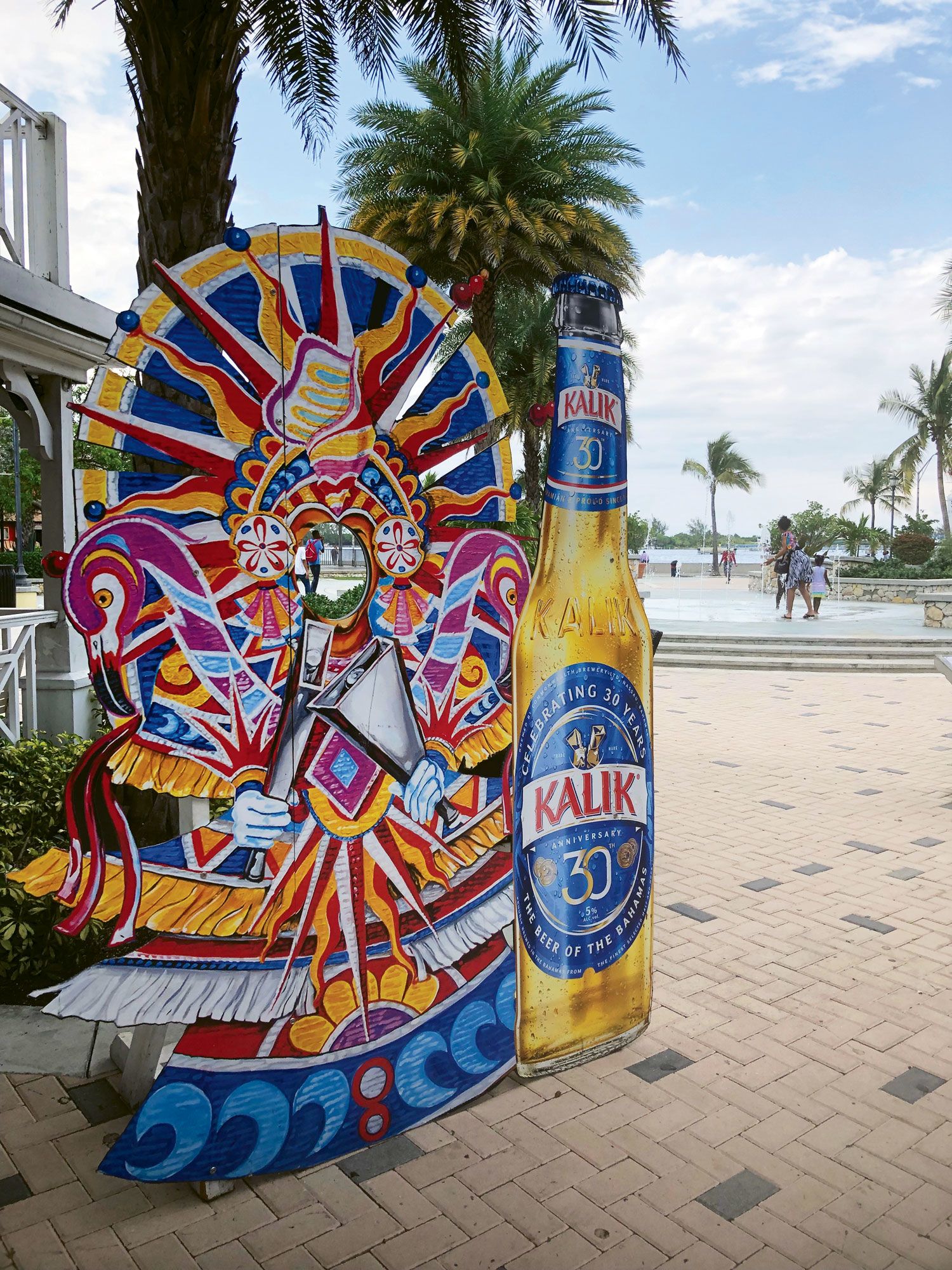 A sign for the Bahamian beer Kalik provides a colorful Junkanoo photo op in Pompey Square in Nassau. (TW photo by Tom Stieghorst)