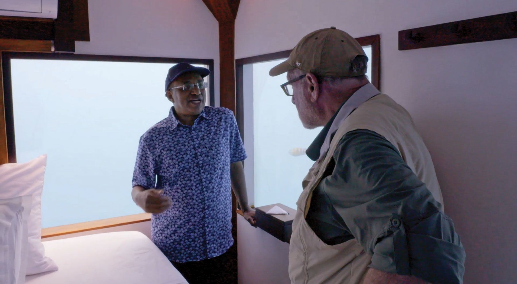 Zanzibar president Hussein Mwinyi and Greenberg in an underwater hotel room at the Manta Resort. (Courtesy Peter Greenberg Worldwide)