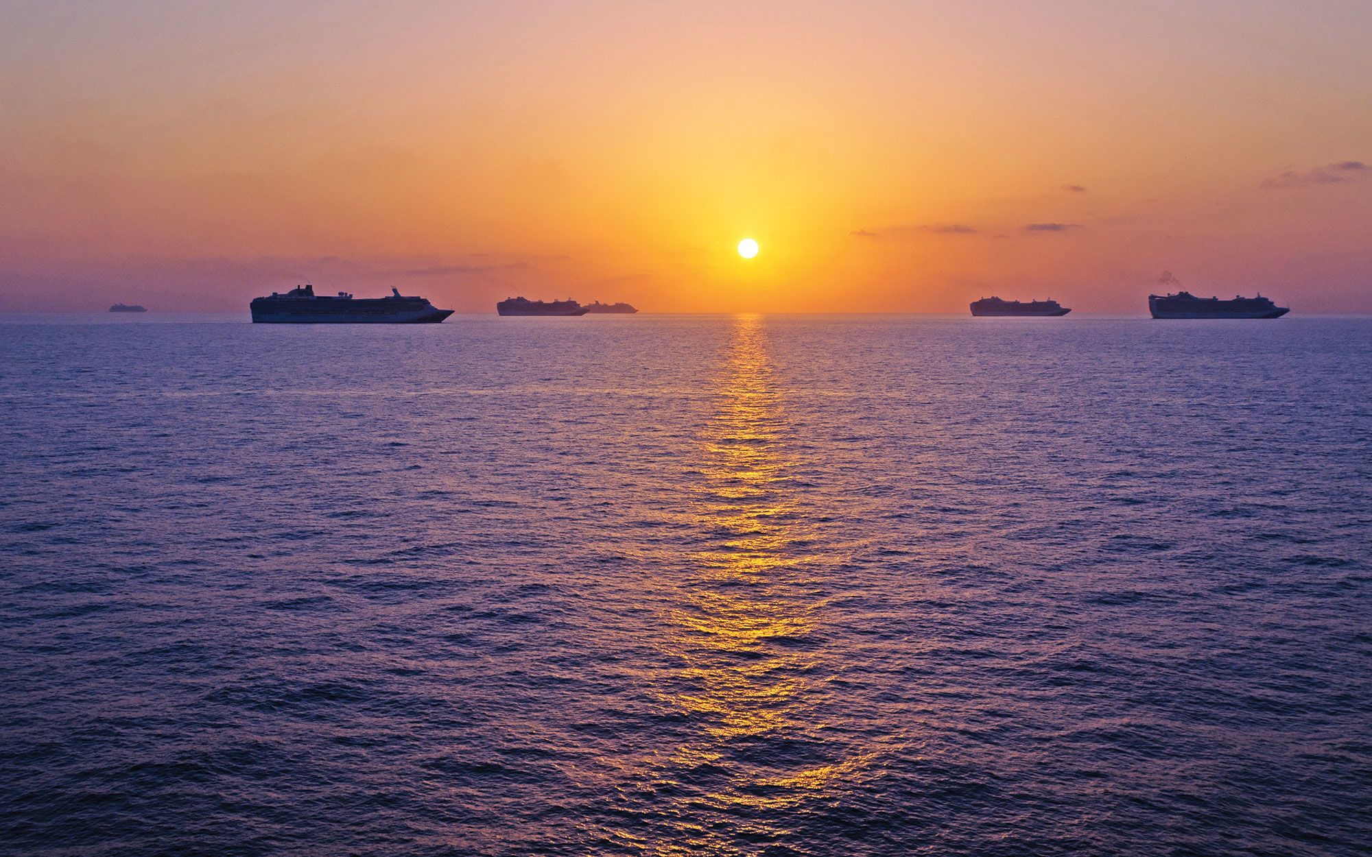 Cruise ships moored off the coast of Bimini, Bahamas, during the Covid-19 shutdown of the cruise industry. (Photo by STUDIO MELANGE/Shutterstock.com)