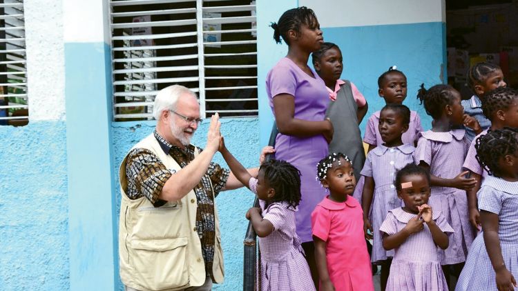 Participants on one of Carnival’s community service excursions visit a school in Jamaica where tour income helped build a lunch room.