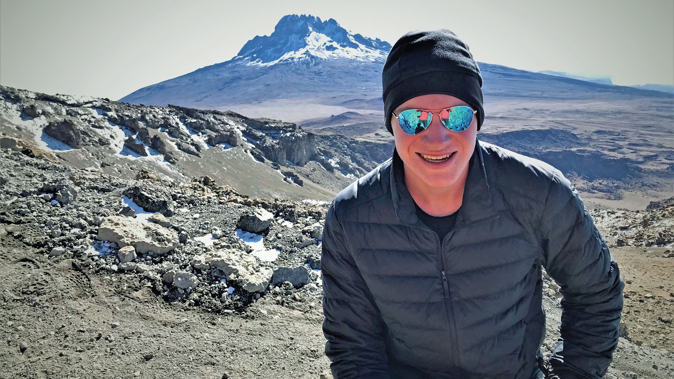 Dash in better spirits at 18,000 feet, posing in front of Mawenzi, an extinct volcano. It was the moment I knew Dash had truly recovered. TW photo by Arnie Weissmann