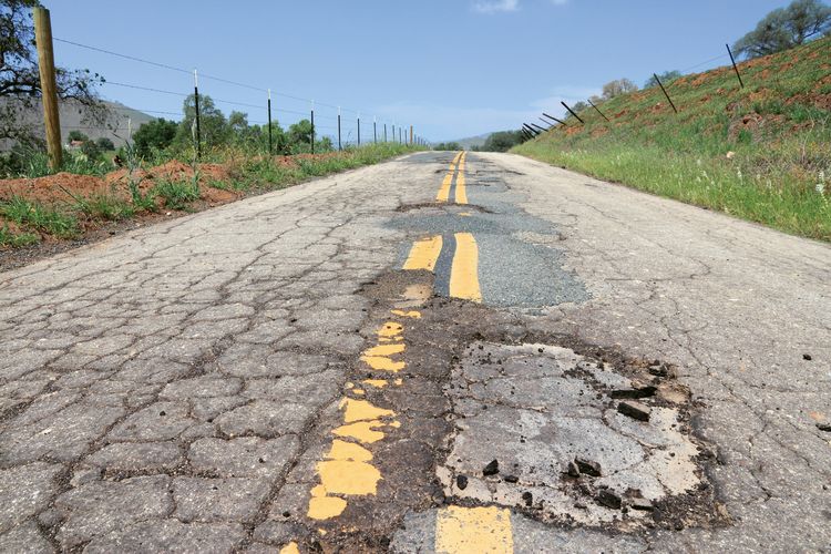 A potholed Yokohl Valley Drive in California’s southern Sierra Nevada. (Photo by Tupungato/Shutterstock)