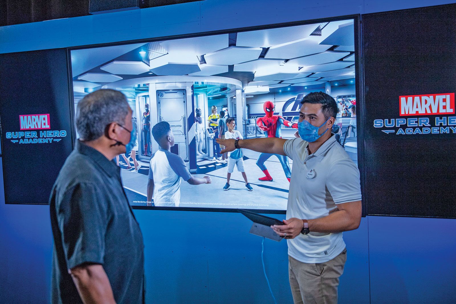Ken Horii, Executive Creative Director, Walt Disney Imagineering (left) and Manny Ramirez, Show Production Designer for Walt Disney Imagineering (right), demonstrating the Super Hero Academy on the Disney Wish.