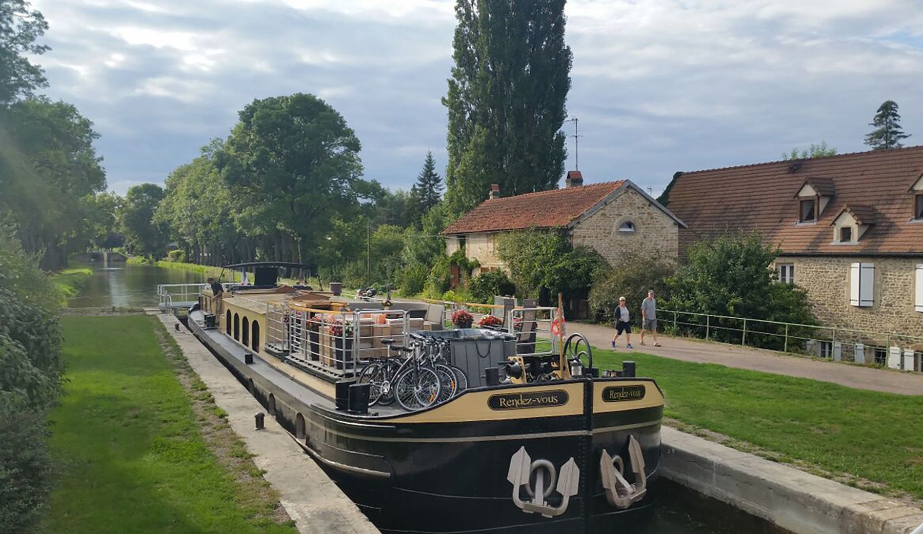 The Rendez-Vous barge navigating a lock in southern Burgundy, France. (Courtesy of Abercrombie & Kent)