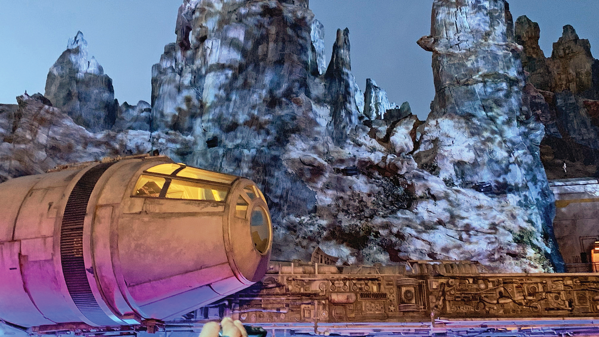 The rugged terrain of planet Batuu, the setting for Star Wars: Galaxy’s Edge, looms over the Millennium Falcon. (TW photo by Jamie Biesiada)
