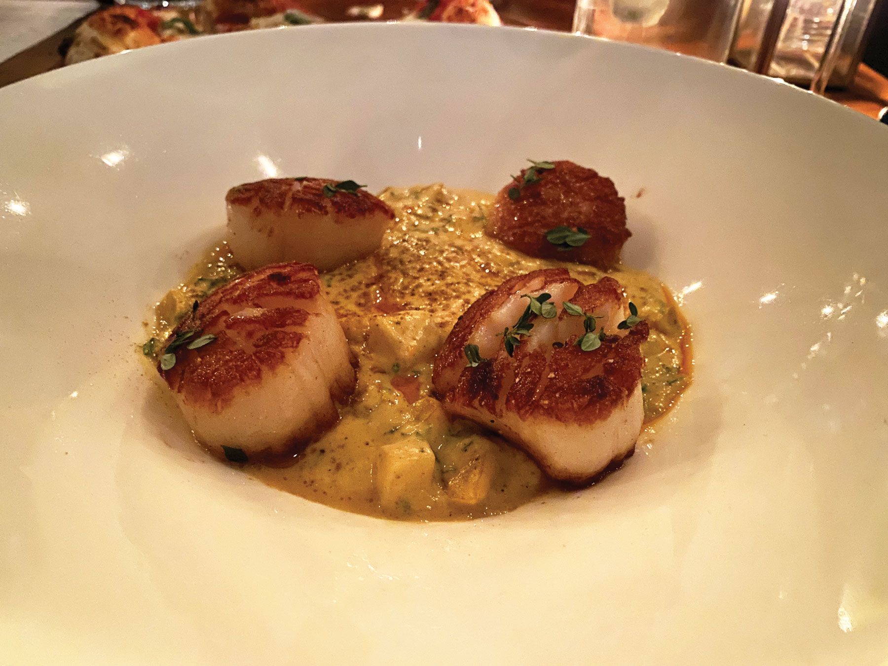 Many of the dishes at Veranda feature Portuguese influences, like sea scallops with “Portuguese Goan spices.” (TW photo by Johanna Jainchill)