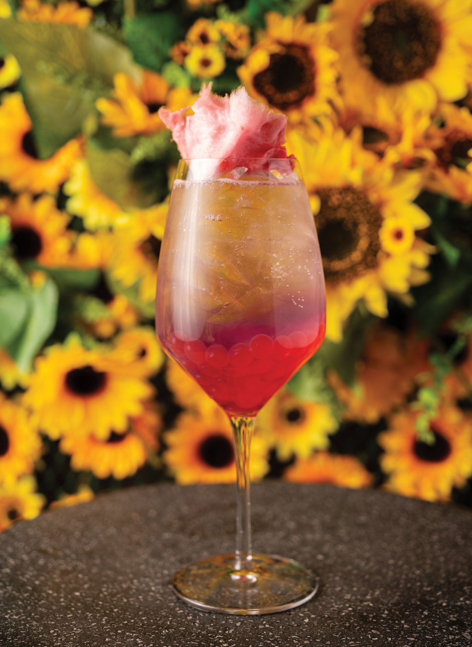 PHD’s most popular cocktail is Cotton Candy Kisses, a prosecco-based drink with house-made Grapefruit Pea Tea Flower infused simple syrup and garnished with edible cotton candy. (Courtesy of PHD Terrace)