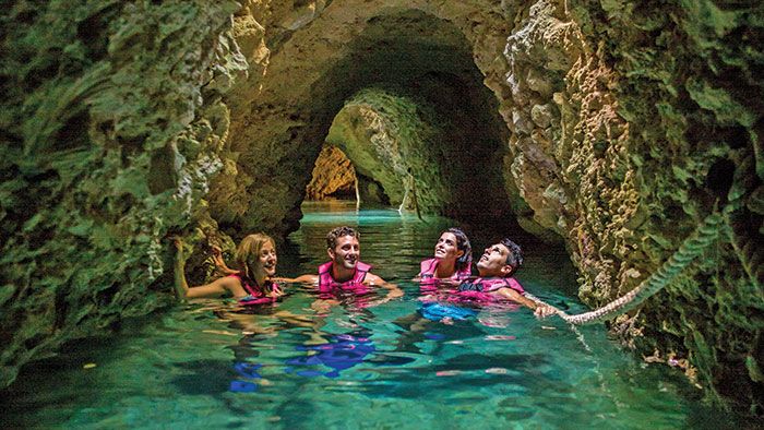 Guests at the Hotel Xcaret, inset right, get access to the eight ecoparks run by Grupo Experiencias Xcaret. Above, the underground rivers at Xcaret Park are part of a natural network of channels in the Yucatan Peninsula.