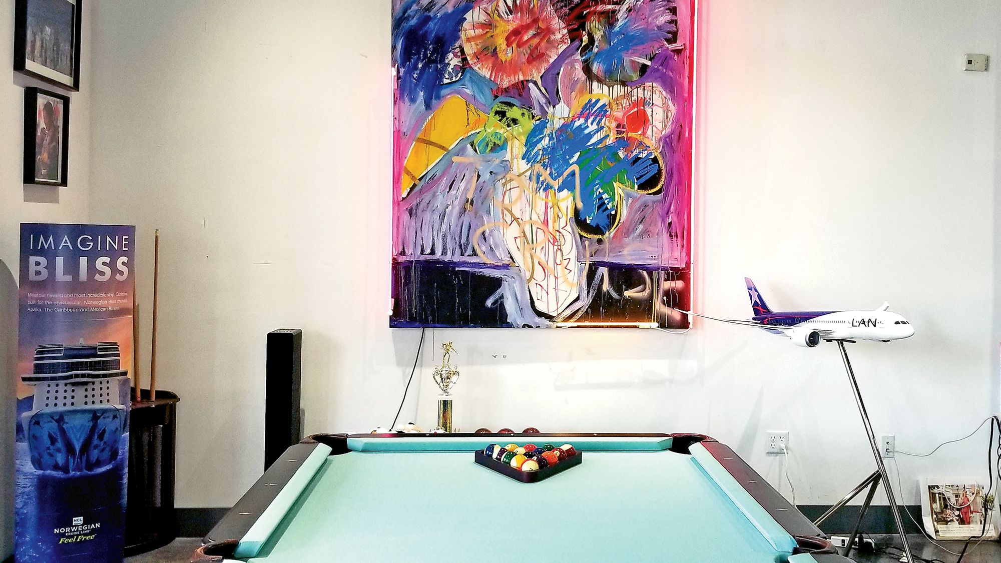 House of Travel in Aventura, Fla., features some leftovers from the space’s former life as a bar — including a pool table — as well as numerous pieces of art collected by owners Jerry and Doris Lang.