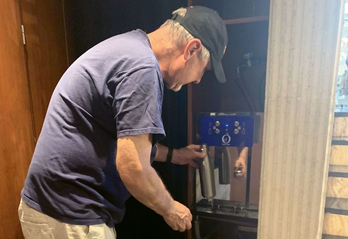 A passenger fills a reusable bottle provided by Tauck at a station onboard one of the company’s river cruise ships. (TW photo by Jeri Clausing)