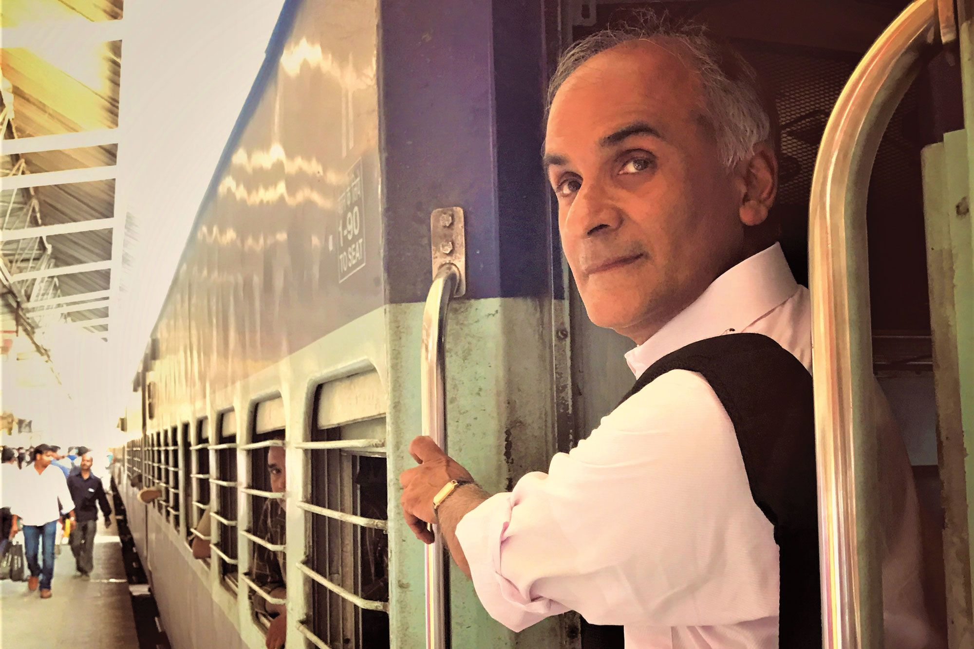 Pico Iyer on a train in Varanasi, India. (Photo by Malek Hue)